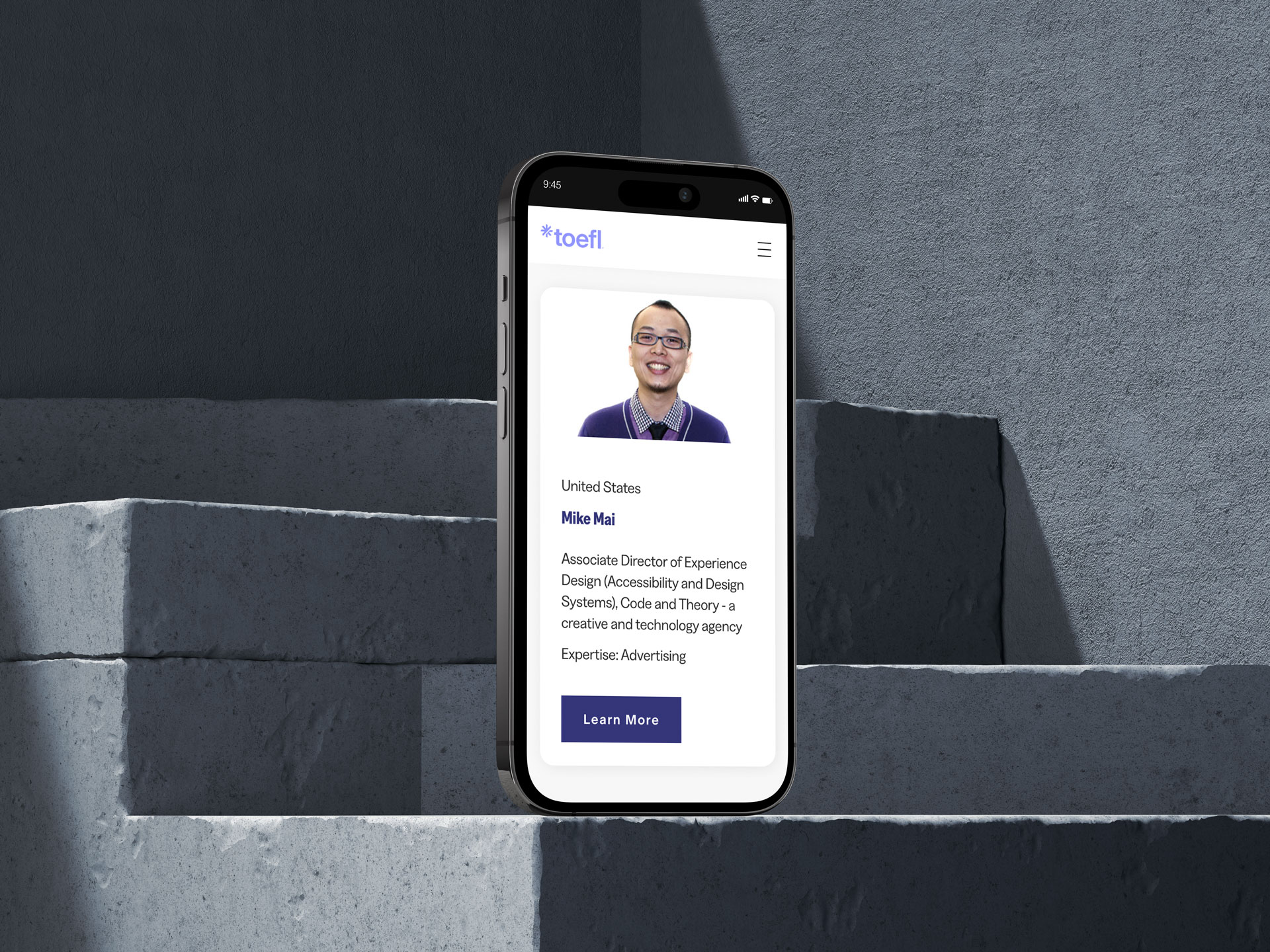 A mobile phone displaying the TOEFL Creating Leaders for 60 Years website. A section of the websites shows the following information: United States, Mike Mai. Associate Director of Experience Design (Accessibility and Design Systems), Code and Theory - a creative and technology agency. Expertise: Advertising.